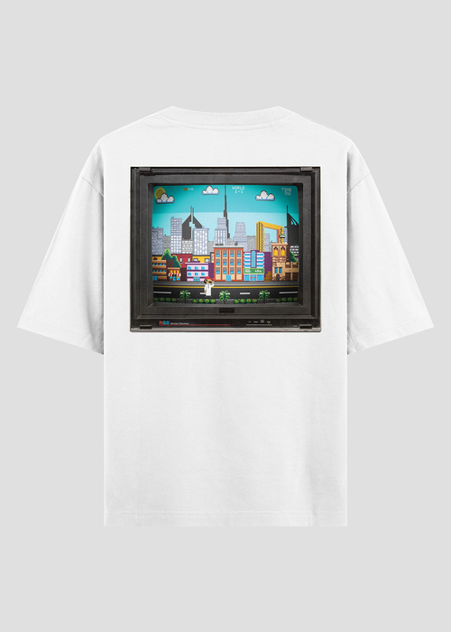 White t-shirt with a colorful cityscape graphic on a gray background