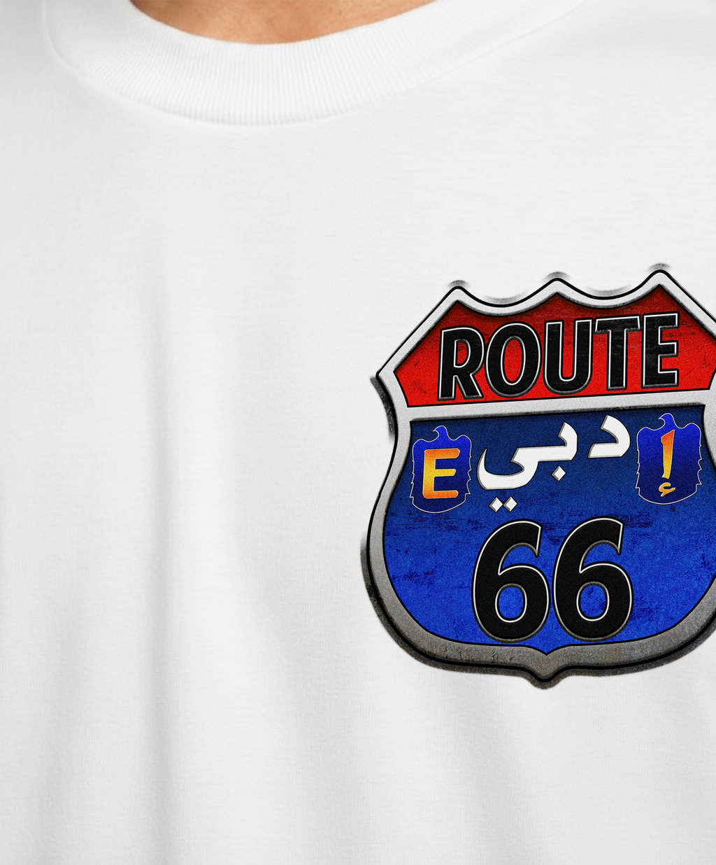 White t-shirt with a Route 66 logo featuring Arabic text on a white background