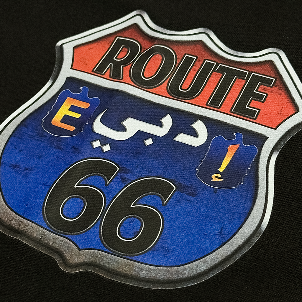 Route 66 sign with Arabic text on a black background